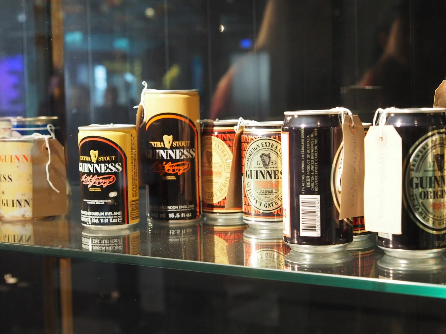 A display of Guinness cans and packaging from different periods.