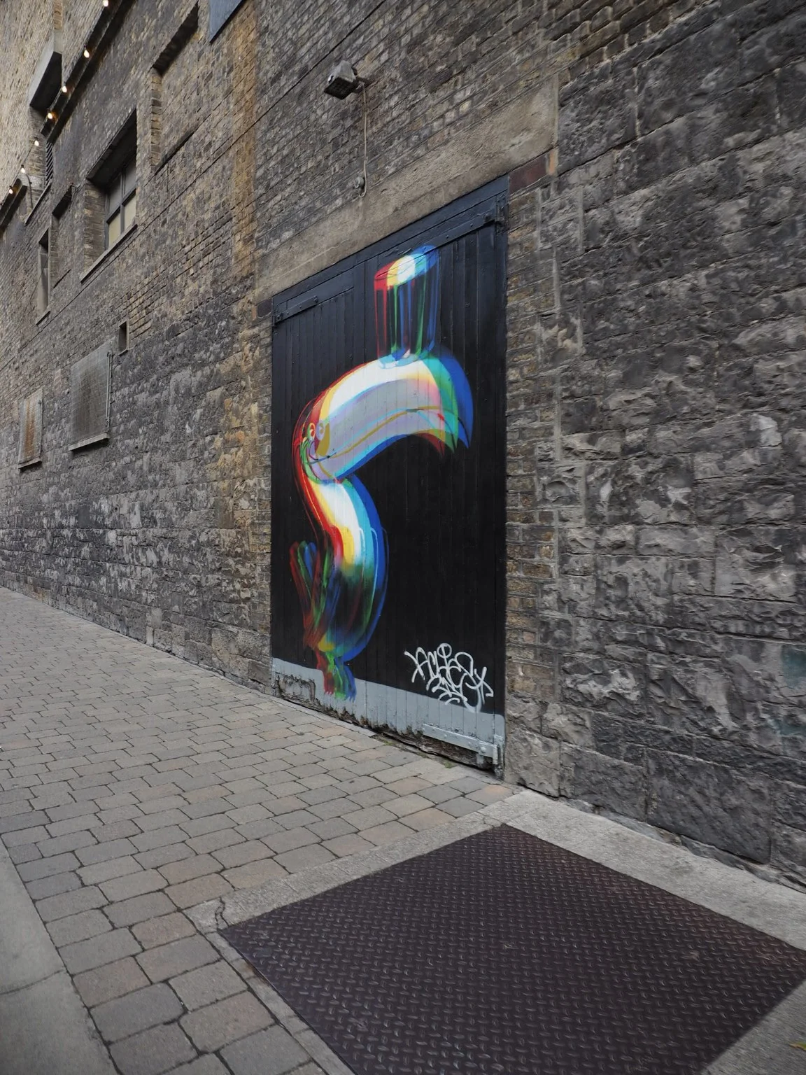A colourful Guinness pint mural on a brick wall near the Storehouse.