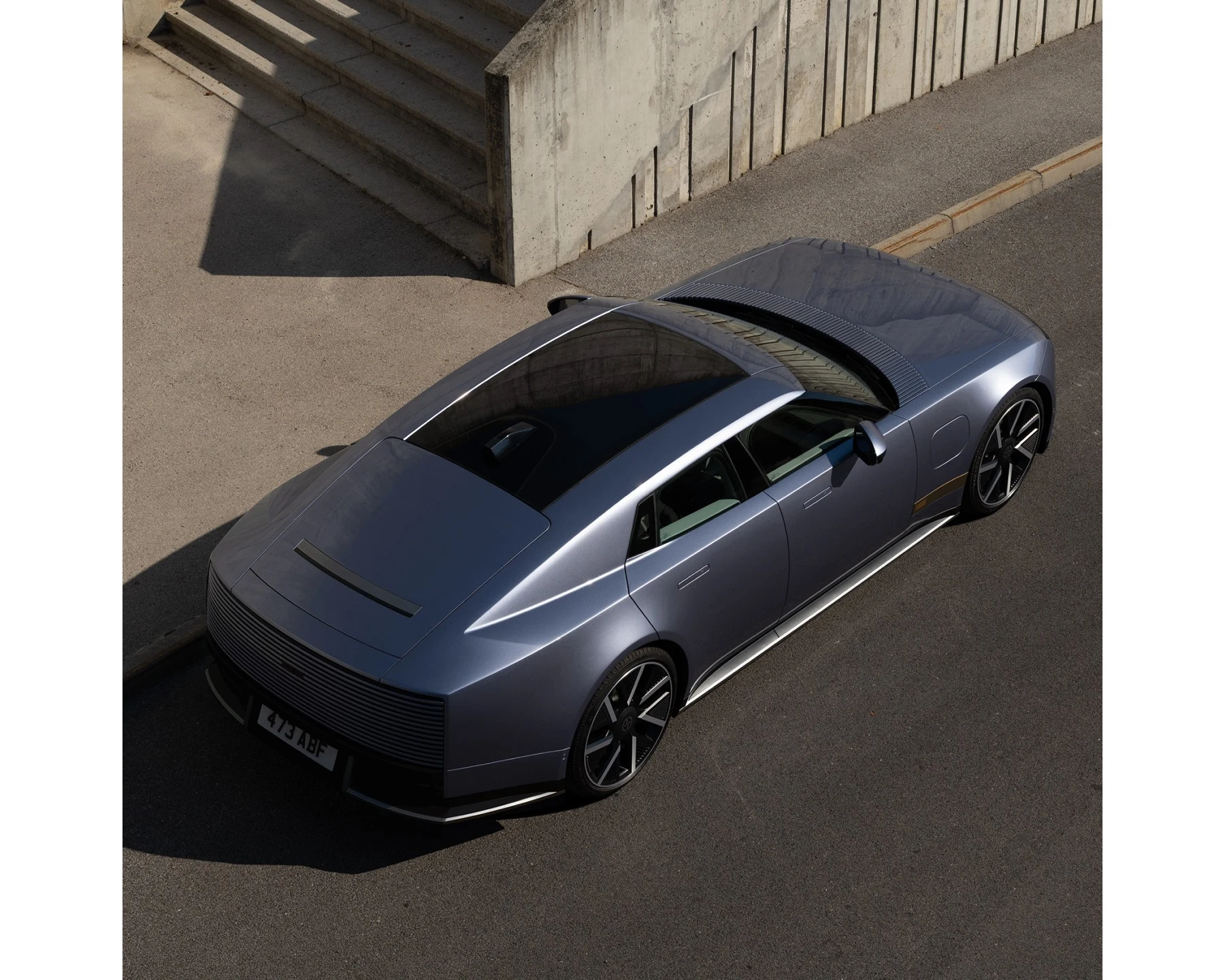 Production Jaguar Type 01 in silver-blue, viewed from above and in front, with a long bonnet and four doors